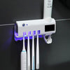TOOTHBRUSH HOLDER WITH STERILIZER AND PASTE DISPENSER