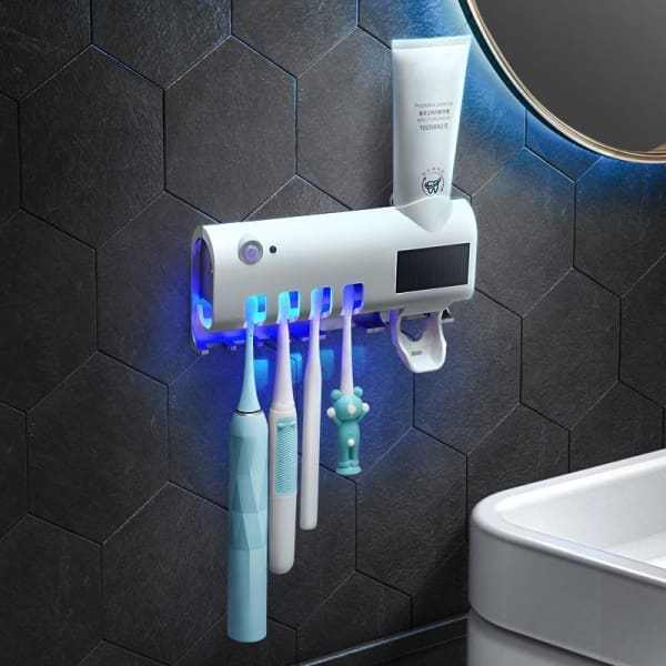 TOOTHBRUSH HOLDER WITH STERILIZER AND PASTE DISPENSER